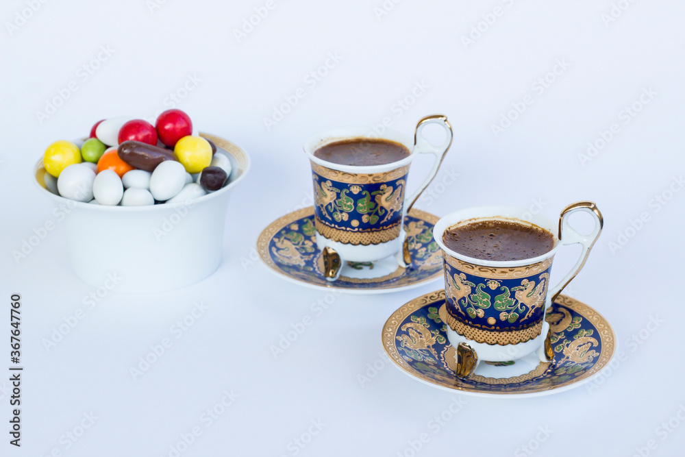 Traditional Turkish Colorful Almond Candies and coffee on white with copy space. Traditional Turkish Colorful Almond Candies and coffee on white with copy space.