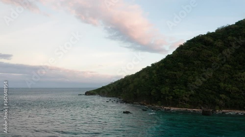 The Lush Green Naviti Island In Fiji Background With Cloudy Sky And Peaceful Ocean - Wide Shot photo