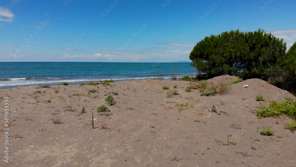 Sandy beach washed by white waves of blue turquoise sea water under bright sky in Mediterranean Sandy beach washed by white waves of blue turquoise sea water under bright sky in Mediterranean