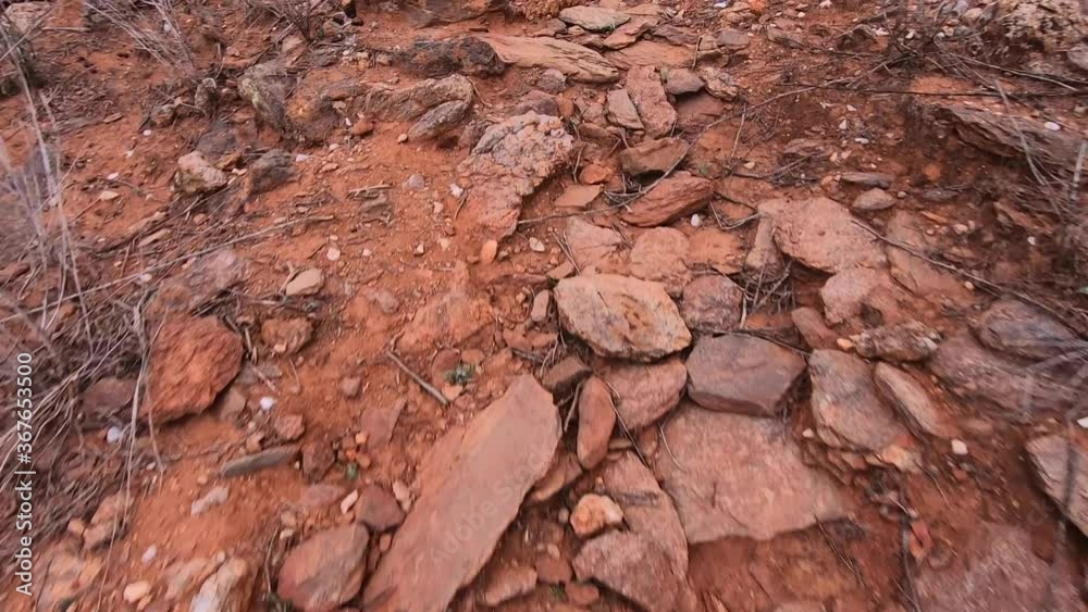 Walking along a dry rocky path in the harsh outback of Australia Walking along a dry rocky path in the harsh outback of Australia