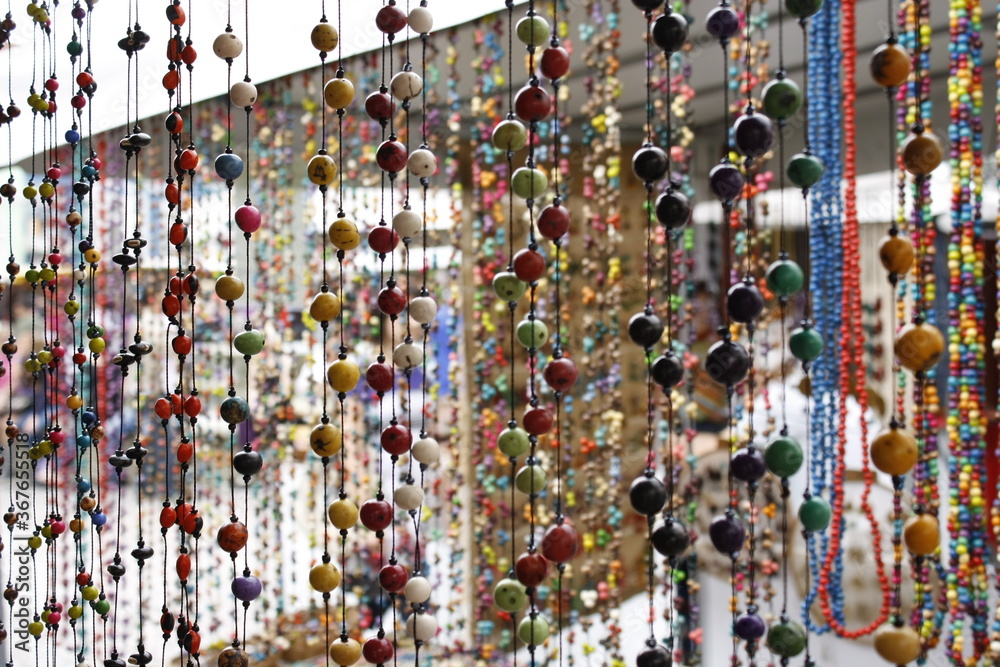 Obraz premium Colorful seed necklaces at craft fair in Brazil. Handcraft. Açaí seeds necklaces. 