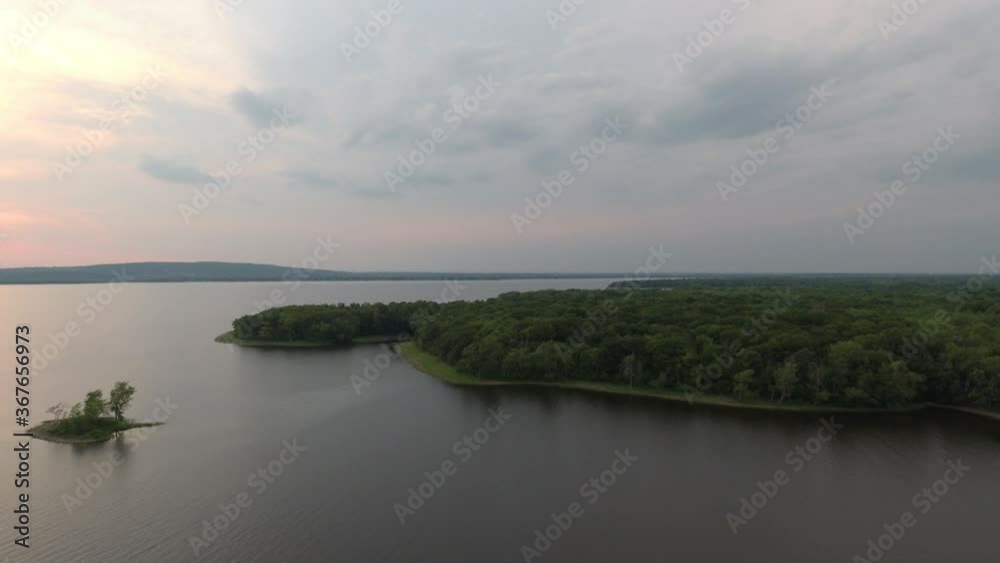 Lush green forest coastline in North America with small island in the vicinity