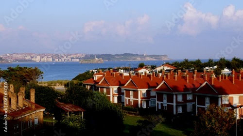 Wallpaper Mural timelapse of the sunrise from a balcony of the Somo beach where the Santander bay is seen in the background, then the Somo beach and the small white tourist buildings with orange roofs Torontodigital.ca