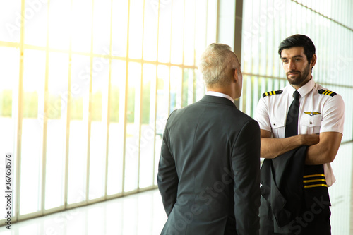 Business executives man and helicopter Commercial pilot in uniform hand shake and talking together