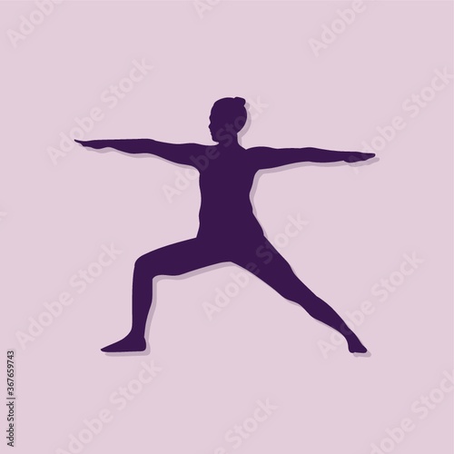 girl silhouette practising yoga in warrior ii pose