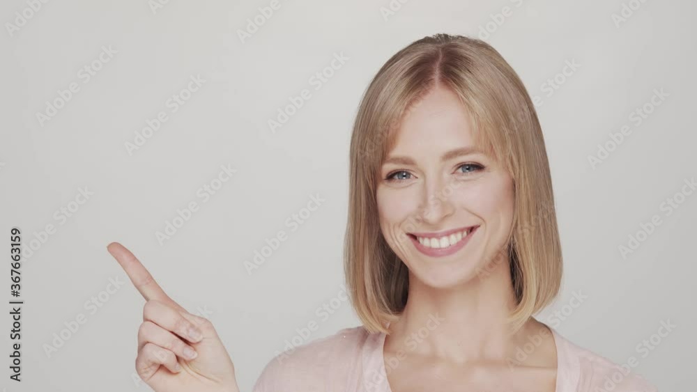 Studio portrait of young and happy woman over grey background Studio portrait of young and happy woman over grey background