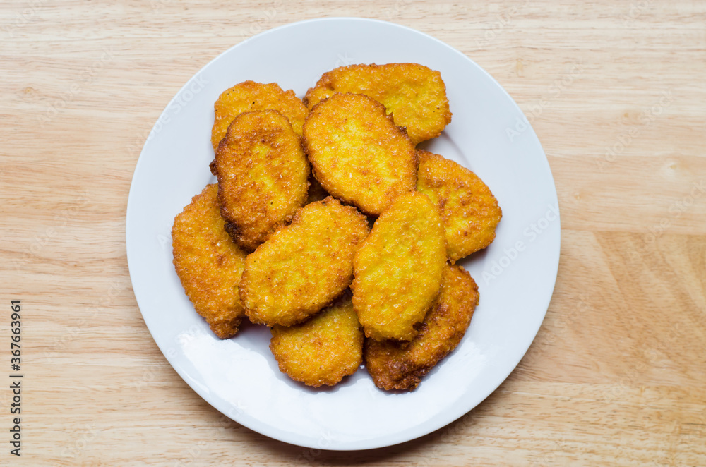 Panamanian style sweet corn fritters on wooden background Panamanian style sweet corn fritters on wooden background