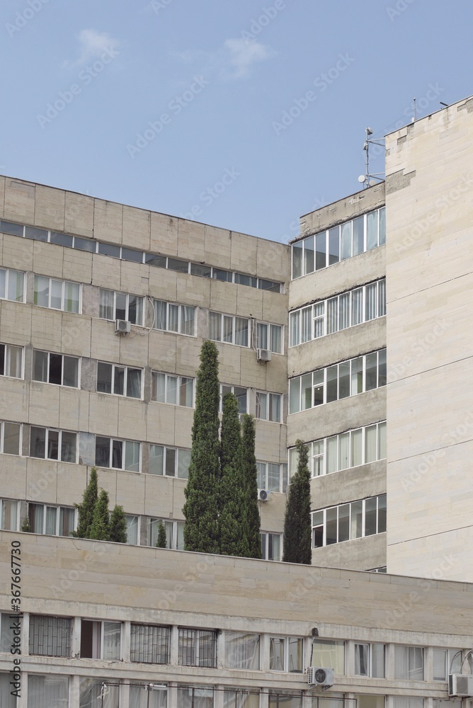 Obraz premium Post Soviet architecture with broken layer on the facade.