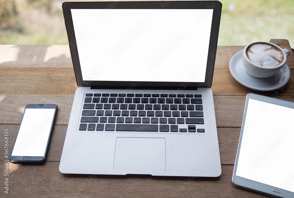 laptop and coffee cup on wood table. View from above at cafe blurred background.
laptop and coffee cup on wood table. View from above at cafe blurred background.