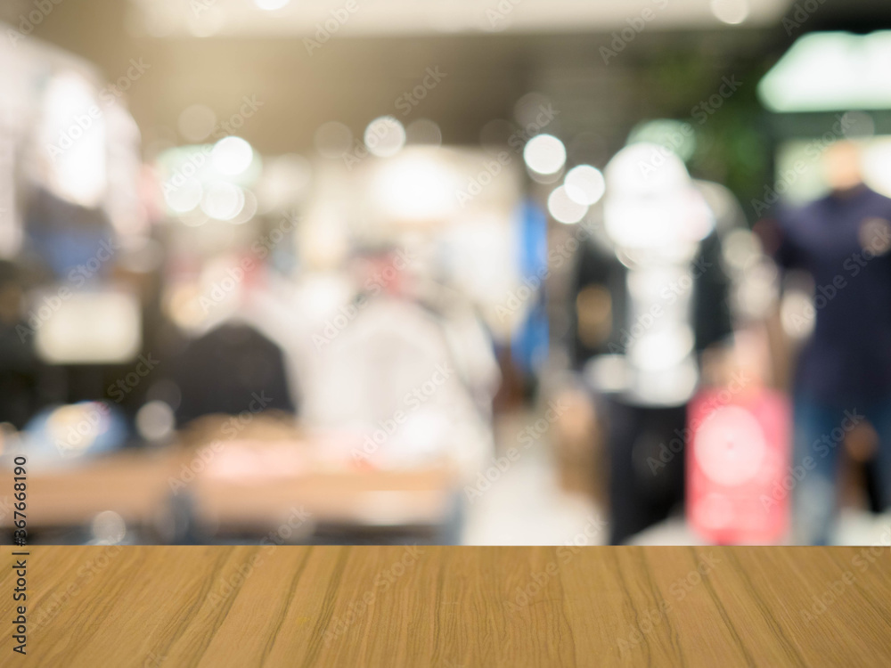 Brown wooden table blurred shopping mall background,display for product montage.
Brown wooden table blurred shopping mall background,display for product montage.