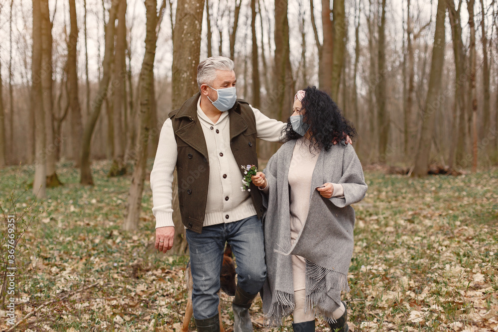 Fototapeta premium Seniors in a forest. People walks. Coronavirus theme.