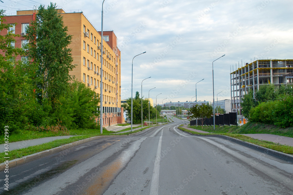 An empty highway with an urban landscape in Siberia