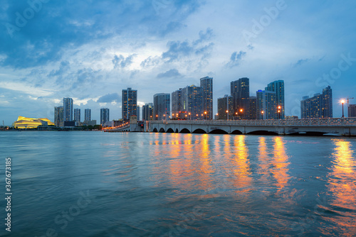 City of Miami Florida skyline and bay with night clouds. Miami night downtown.