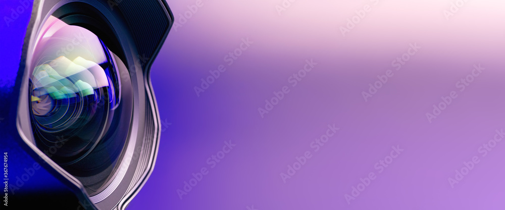 Fotografie .Banner. The camera lens with purple backlight. Optics. Technological background