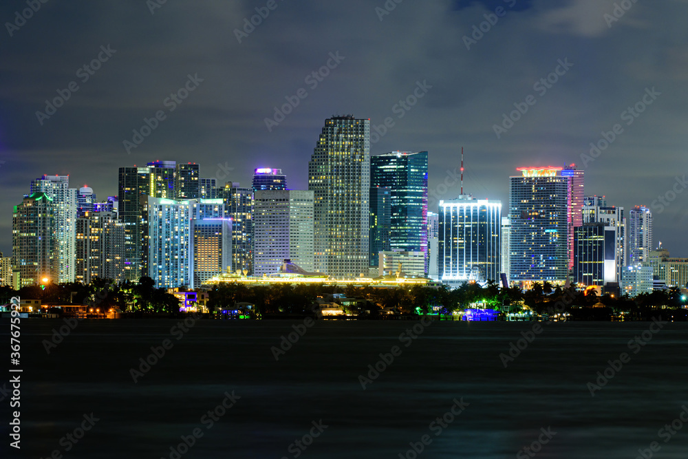 Miami business district, lights and reflections of the city lights. Miami, Florida, USA skyline on Biscayne Bay, city night backgrounds.