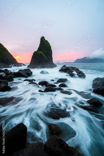 misty sunset at payangan beach ambulu jember east java indonesia photo