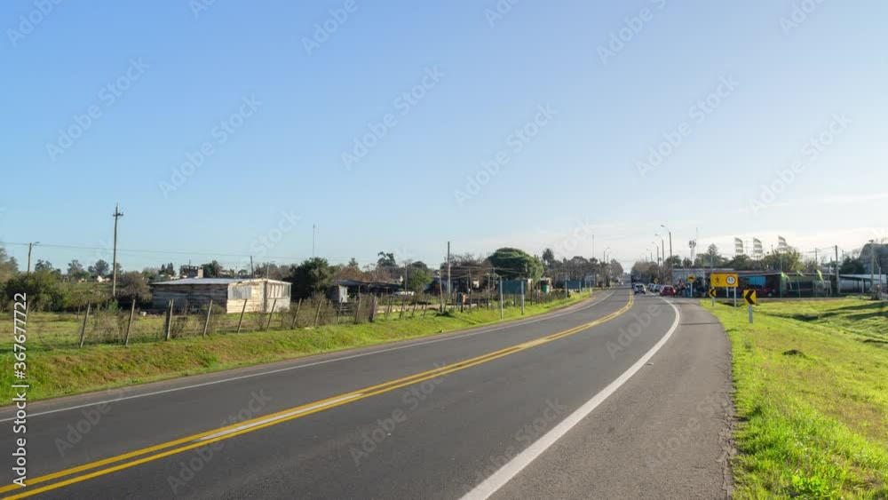 Traffic on the entrance route to rural village, time lapse