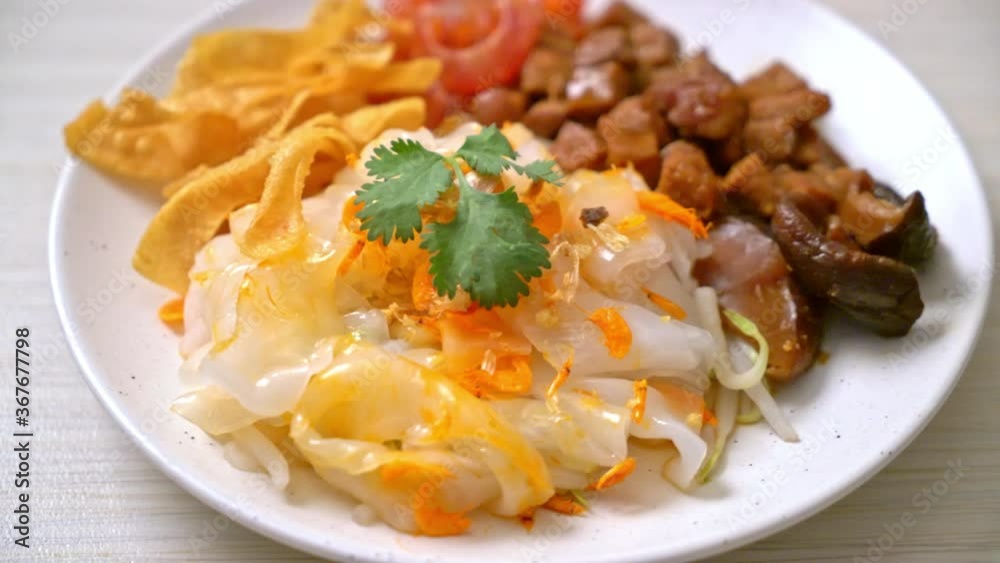 Chinese steamed rice noodle with pork and tofu in sweet soy sauce - Asian food style Chinese steamed rice noodle with pork and tofu in sweet soy sauce - Asian food style