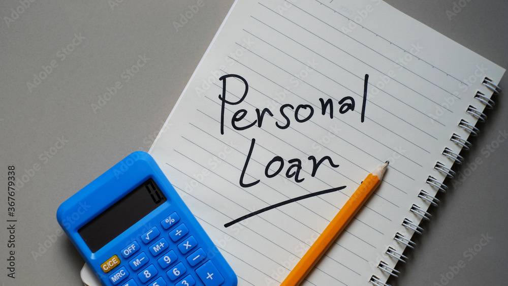 Personal Loan written on a notebook, calculator and pencil. Personal Loan written on a notebook, calculator and pencil.