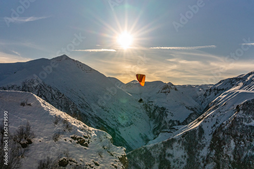 Paraglider on top of Caucasus, in winter time, shot in Georgia.