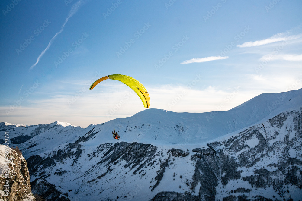 Paraglider on top of Caucasus, in winter time, shot in Georgia. Paraglider on top of Caucasus, in winter time, shot in Georgia.
