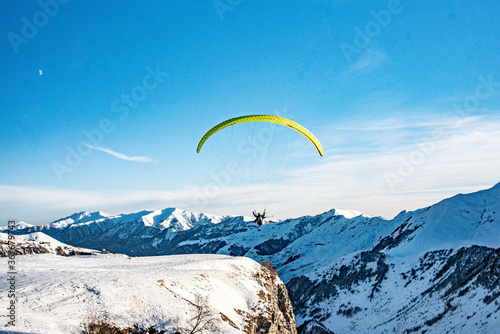 Paraglider on top of Caucasus, in winter time, shot in Georgia.