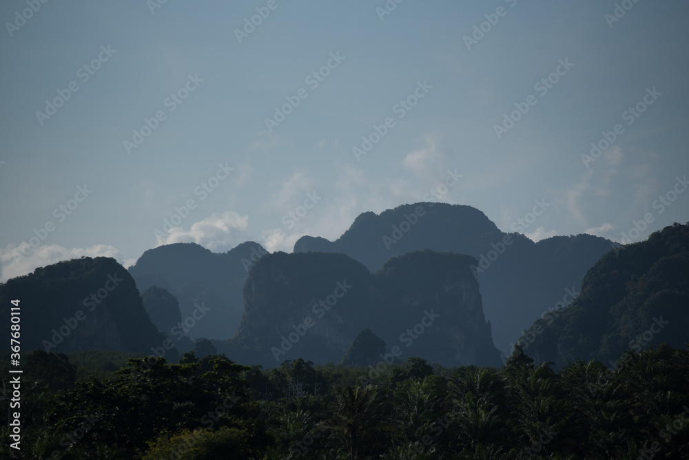 Cliff and rocky mountain range in the fog 