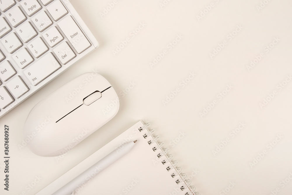 Business concept of office desk, flat lay. Workplace top view, copy space. Workspace on a white background with a keyboard, computer mouse and a blank notepad. Business concept of office desk, flat lay. Workplace top view, copy space. Workspace on a white background with a keyboard, computer mouse and a blank notepad.