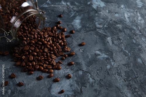 Coffee crumbled from a jar, on a dark concrete background. Copy space.