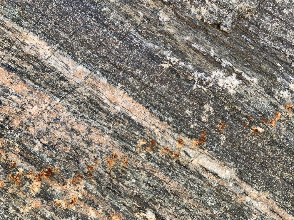 Background texture: the structure of a large stone. Granite boulder close up. Irregularities and cracks in the stone rock. Concept - stone, hardness Background texture: the structure of a large stone. Granite boulder close up. Irregularities and cracks in the stone rock. Concept - stone, hardness