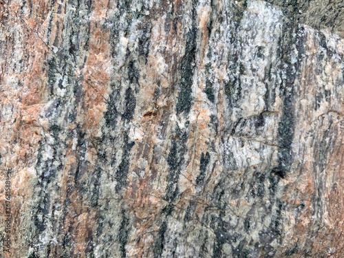 Background texture  the structure of a large stone. Granite boulder close up. Irregularities and cracks in the stone rock. Concept - stone  hardness