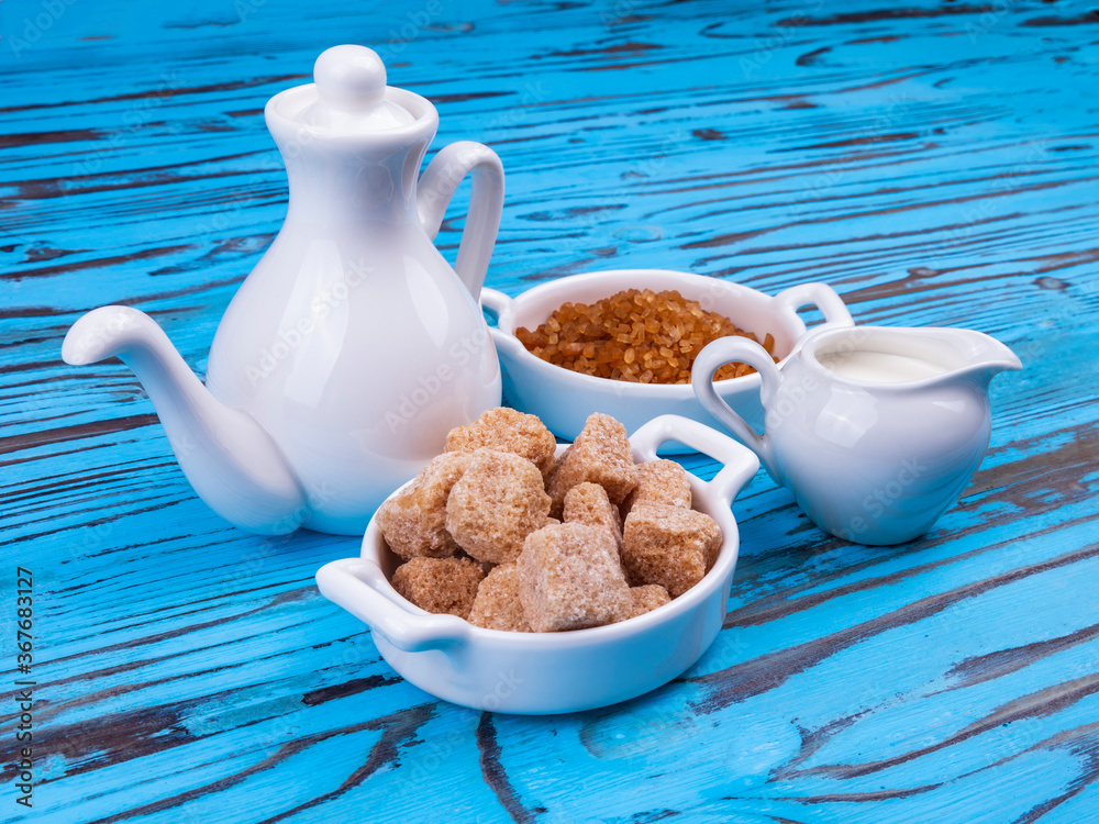 Table setting for coffee. Milk jug, coffee pot, and small saucers with