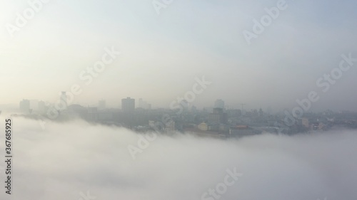 Fototapeta Naklejka Na Ścianę i Meble -  Aerial view of the city in the fog.