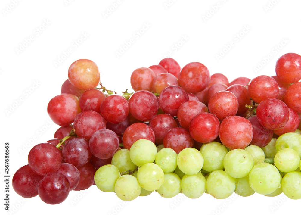 Bunch of green grapes with red grapes with water drops on them, isolated on white background.