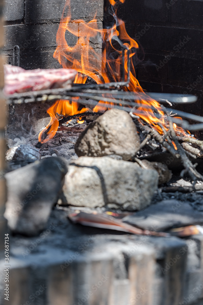 Closeup take of a traditional Argentinian and Uruguayan barbecue, Creole sausage, whit peppers and eggs Closeup take of a traditional Argentinian and Uruguayan barbecue, Creole sausage, whit peppers and eggs
