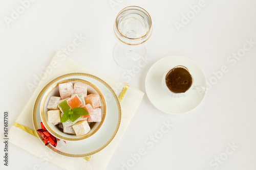 Traditional Turkish Delight on white background with Turkish Coffee.The Sugar Festival.