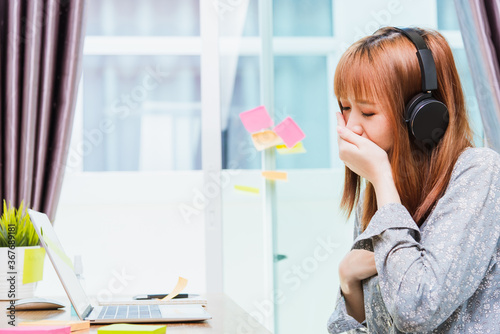 Work from home concept, Asian beautiful young woman, student girl tired sleepy yawning use hand close mouth during working with laptop computer at home office