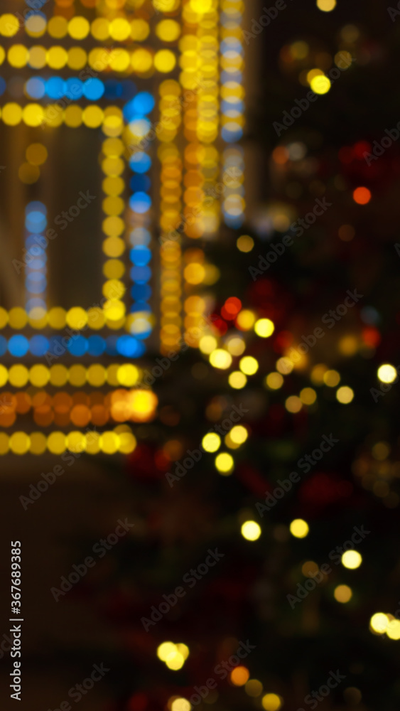 Colorful bokeh defocused Christmas fairy lights, New Year's fair