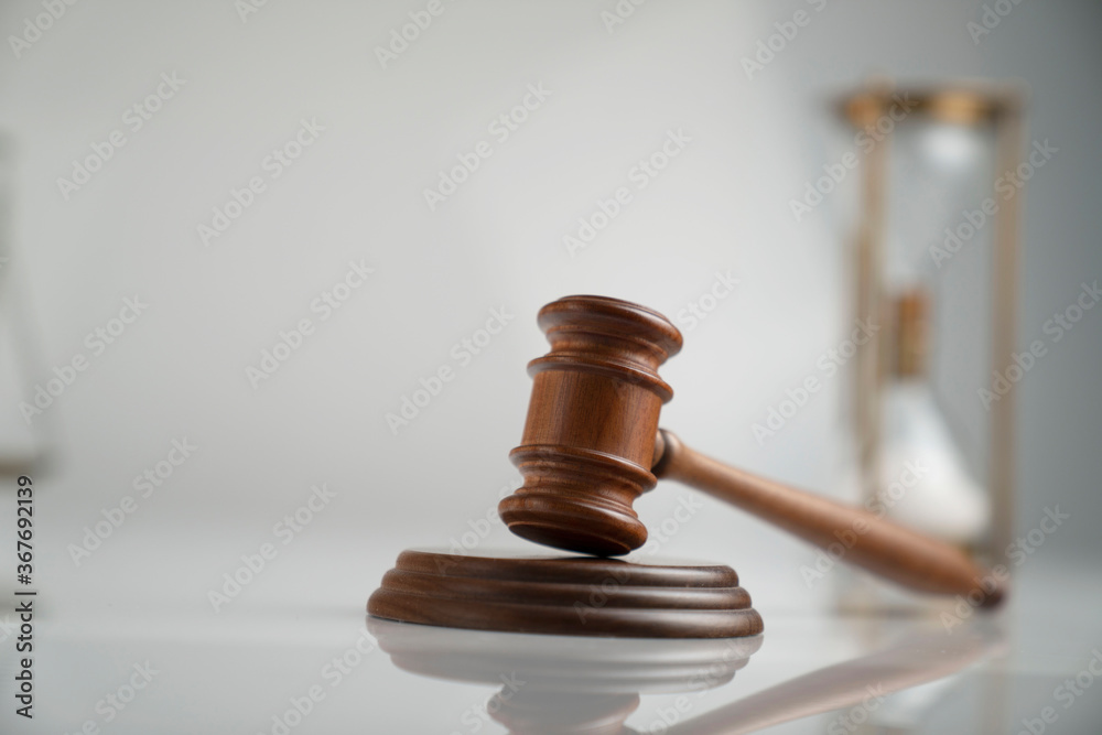 Law and justice concept. Scale, gavel and hourglass on off-white background. Law and justice concept. Scale, gavel and hourglass on off-white background.