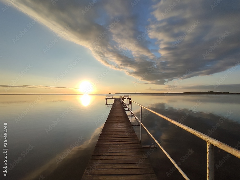 Naklejka premium beautiful boardwalk during sunrise at lake Müritz