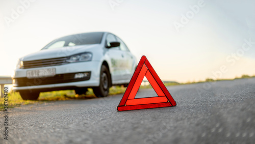red triangle sign on the road as the symbol of the car crash accident on highway