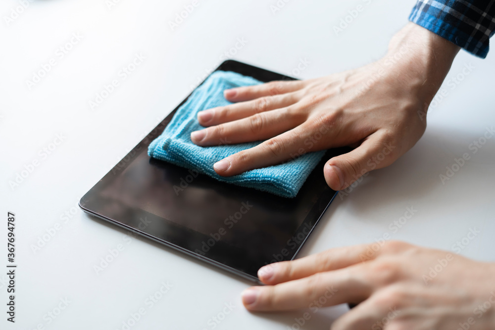 hand holding a rag and wipe a digital monitor screen of device hand holding a rag and wipe a digital monitor screen of device