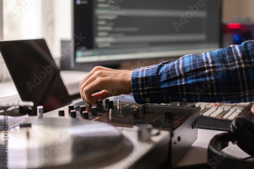 man in the home music studio, creating new song, making sound production with vintage equipment