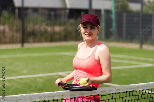Woman playing tennis and waiting for the service