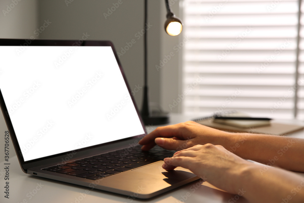 Woman working with modern laptop at white table, closeup Woman working with modern laptop at white table, closeup