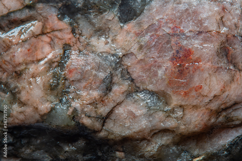 High granular texture of natural granite with color stains and small details on the surface in light blur with soft focus High granular texture of natural granite with color stains and small details on the surface in light blur with soft focus