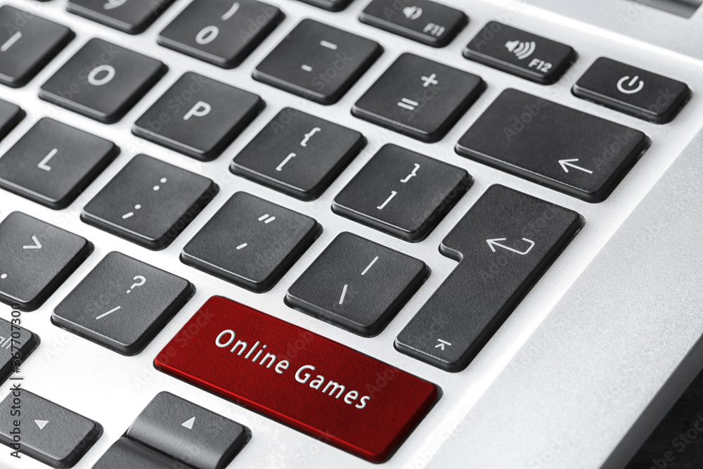 Laptop keyboard with button Online Games, closeup Laptop keyboard with button Online Games, closeup