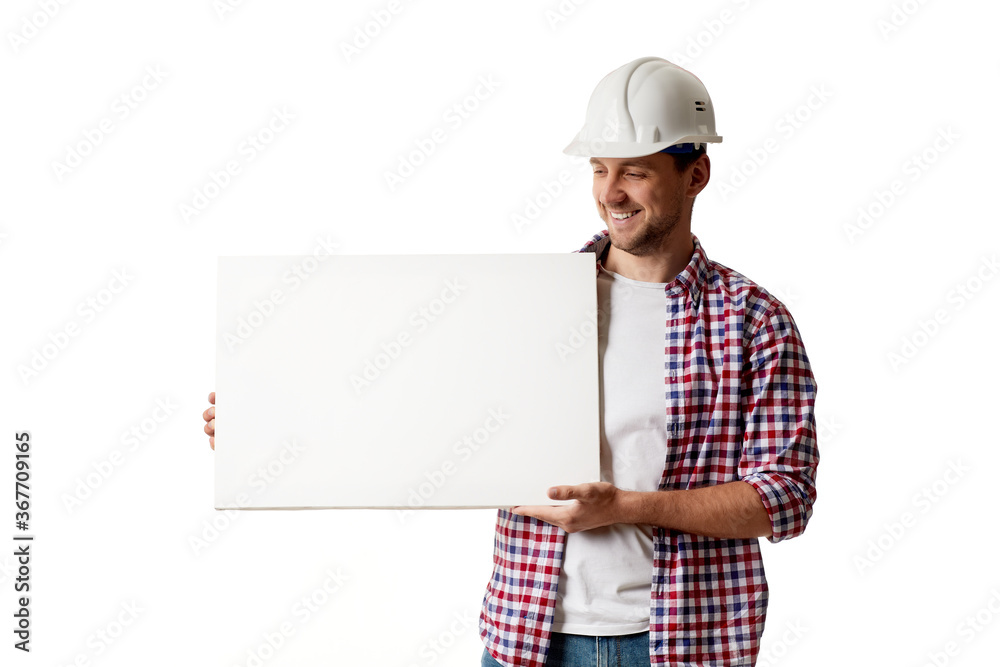 smiling handyman worker in hard hat holding empty blank board. builder in shirt isolated on white studio background smiling handyman worker in hard hat holding empty blank board. builder in shirt isolated on white studio background
