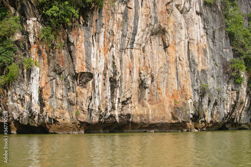 Eroded overgrown limestone rocks in Phang Nga Bay, Ao Phang Nga Marine National Park, Thailand,