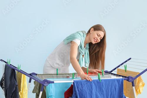 Woman hanging clean clothes...